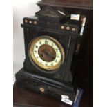 A Victorian black slate mantel clock with key