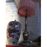 A table lamp and an eastern vase with a lid