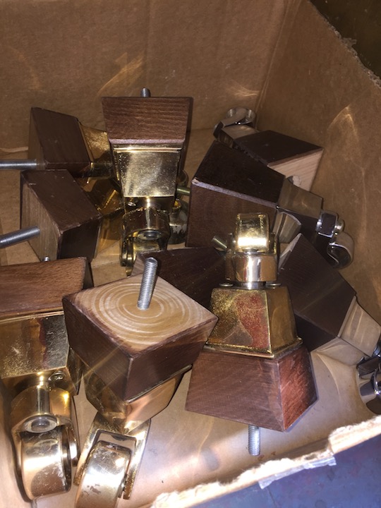 A box of wood and brass castors.