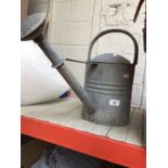 A galvanised watering can