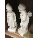 A pair of plaster figures - boy & girl.