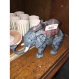 A cast iron money box / door stopper in the form of an elephant.