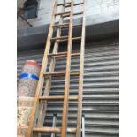 A set of large wooden extending ladders