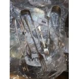 A small bag of silver cutlery and sugar tongs