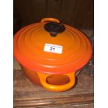 A Le Creuset pot with lid.