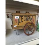 A small wooden toy ice cream cart