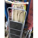 An ironing board and step ladders