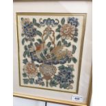 A 20th century Chinese embroidery with a bat and lotus flowers, 18cm x 23cm, glazed and framed.