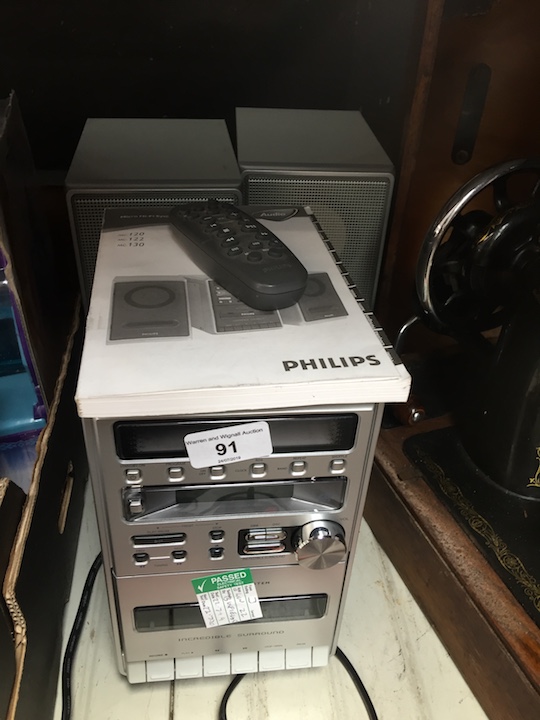 A Philips micro hi-fi system with pair of speakers, remote and manual.