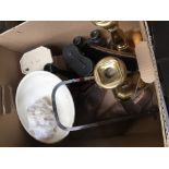 A box of collectables to include 2 pairs of binoculars, a pair of brass candlesticks, a cast iron