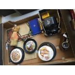 A box with various items including a Yoshika camera, Le Jockey Club - Paris binoculars, plaques,