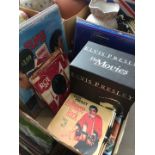 A box of Elvis Presley records, 45s LPs, video cassettes etc