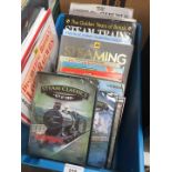 A box of railway books and DVDs