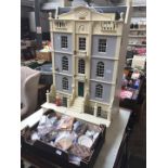 A Miniature Mania 4 story townhouse Dolls house with a box of furniture.