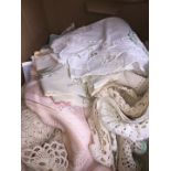 A box of linen to include macrame, doilies, etc.