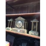 A 19th century onyx mantle clock with garniture.