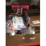 A box of assorted items including sealants, head set stands and a box of glasses