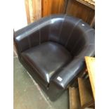 A brown leather tub chair.