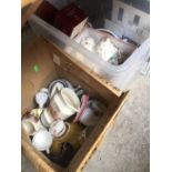 A crate and a box of various plates, ornaments etc