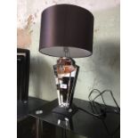 A modern Art Deco style mirror table lamp.