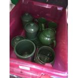 A box of green pottery, storage jars, trivet, teapot and mugs