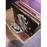 A box of LPs including easy listening, Judas Priest, AC/DC, Foeigner, U2
