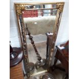 A modern gilt frame mirror with beveled edge