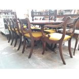 An inlaid extending dining table with 8 chairs