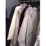 A collection of clothing items comprised of 3 trench coats, 4 leather jackets and another coat.