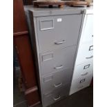 A grey metal 4 drawer filing cabinet