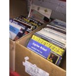 Two boxes of football programmes