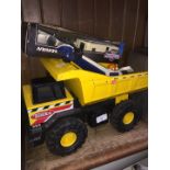 A Tonka truck and a collection of other toys.