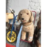 A child's Raleigh tricycle and a ride on dog.