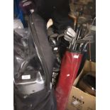 Four golf bags with clubs and a lightweight Titleist golfbag