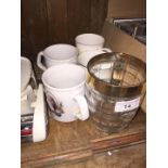 A collection of Royal souvenir mugs and a tankard