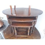 An oval oak nest of tables by Old Charm