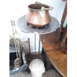 A stoneware pot with lid, metal stand and copper pot