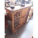 A 1930s carved oak bureau bookcase.