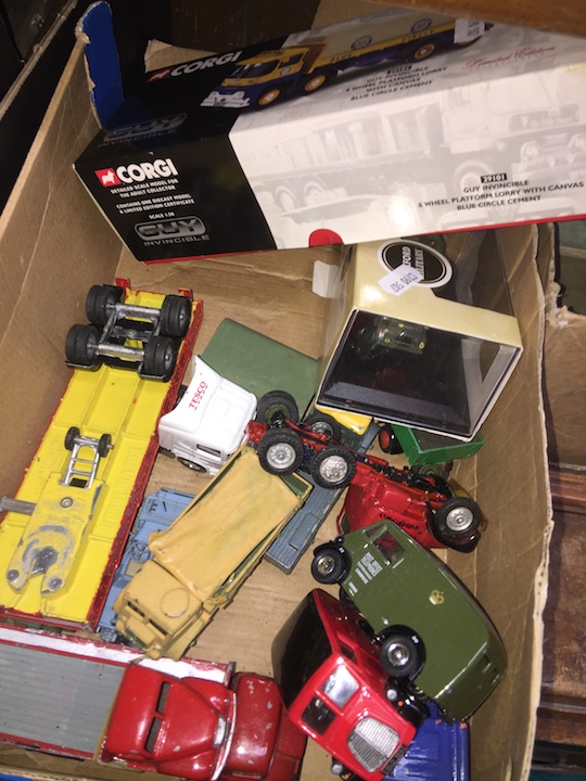 A box of Dinky and Corgi die-cast toys.