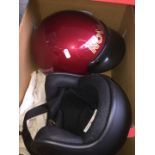 A box containing two motor cycle helmets