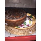 A carved wooden lidded bowl, an hors d'oeuvres bowl and a shallow wicker basket