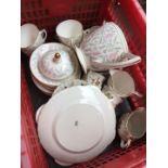 A Minton Petunia tea set and others in a red crate