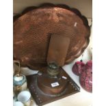 A large copper tray and a copper table lamp.