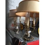 A pair of brass lamps with shades