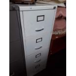 A metal white 4 drawer filing cabinet