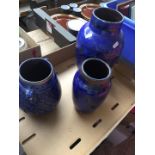 Three blue vases in a box