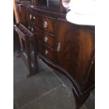 A mahogany reproduction serpentine sideboard