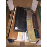 A box of technical drawing instruments