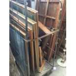 A large quantity of pictures, mirrors and a table top display cabinet