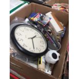 A box of misc including a knife block, tubes of adhesive, wall clock etc
